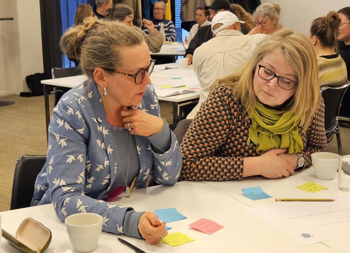 Gruppesamtaler ved borde med post-its